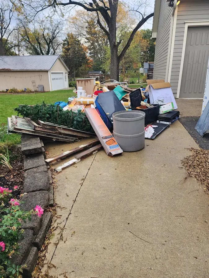 Dumpster being loaded with debris for Commercial Dumpster Rental in Cedar Grove